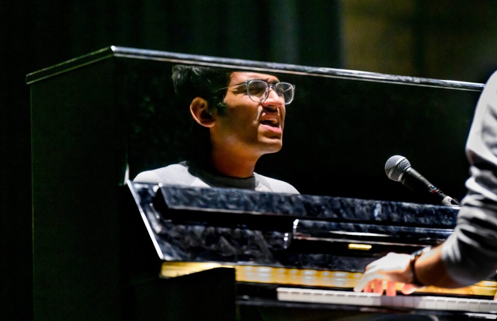 Student performing at a piano during the fifth annual Global Talent Show at Lincoln Hall Theater
